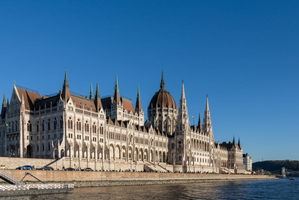View of the Hungarian Parliament Building during river cruise at sunset.