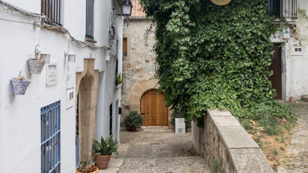 Old Town Caceres | Krista the Explorer Narrow cobblestone street in a Mediterranean village.