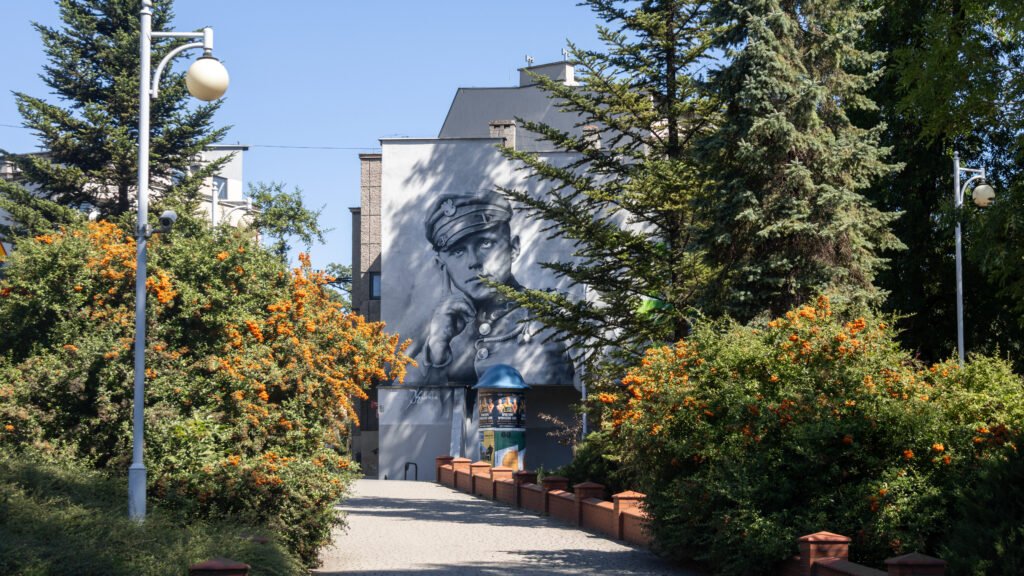 Black-and-white mural of a military officer on a building.