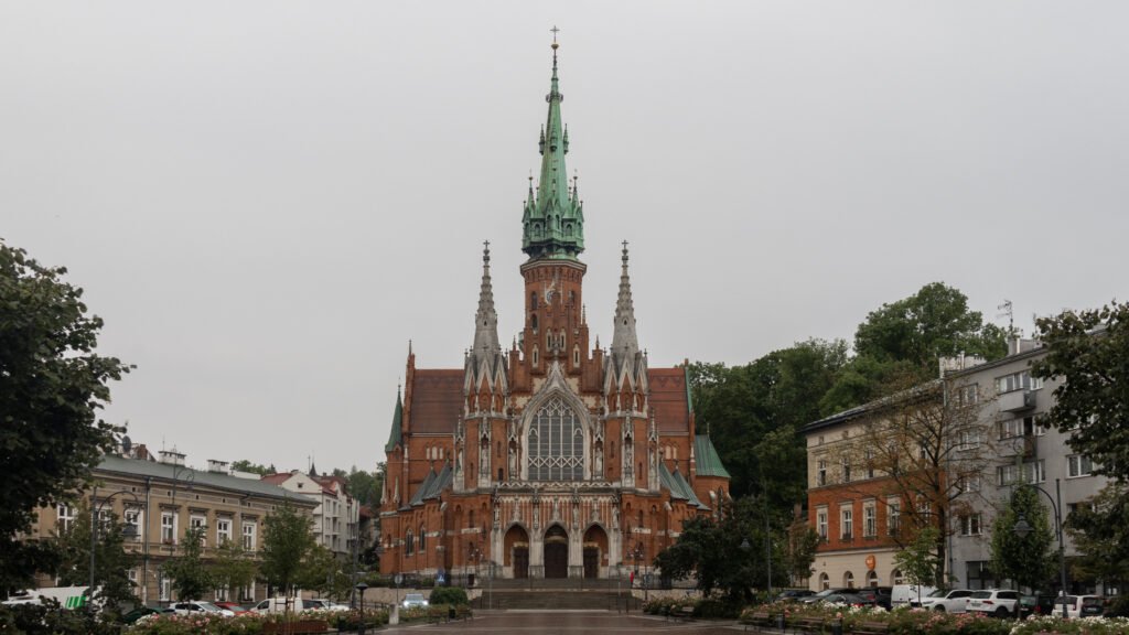 St Joseph’s Church Krakow | Krista the Explorer Gothic red-brick church with a tall green copper spire.