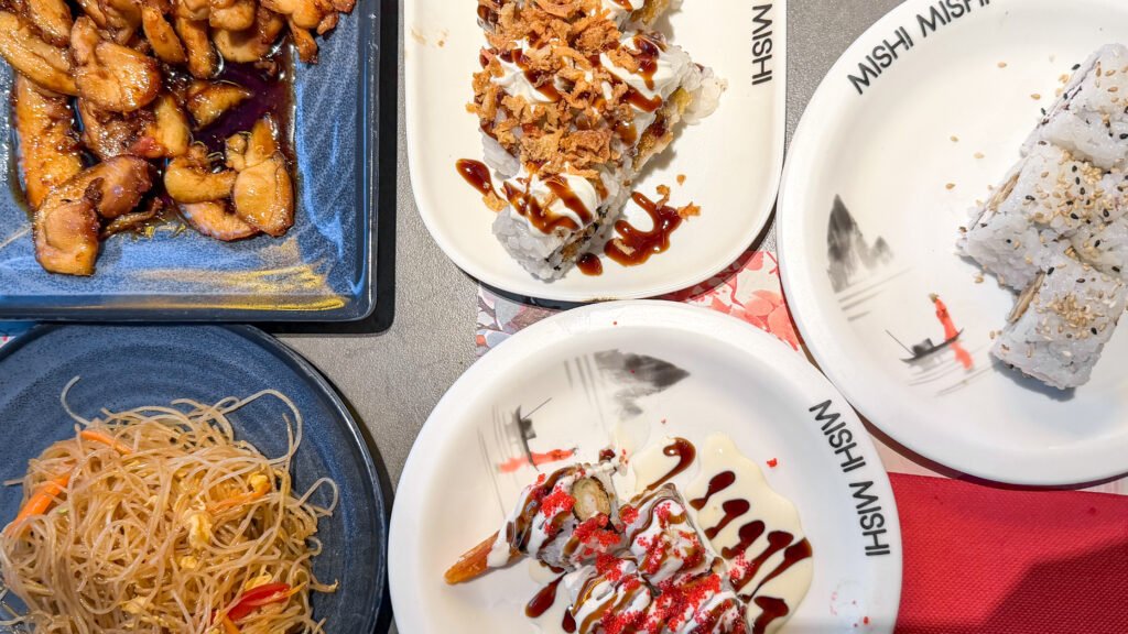 Mishi Mishi Caceres | Krista the Explorer Assorted Asian buffet dishes on table in restaurant.