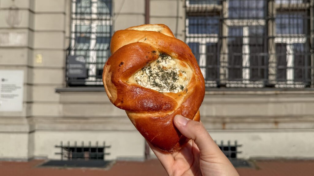 Hand-held soft pretzel twisted around a dollop of herbed cream cheese.