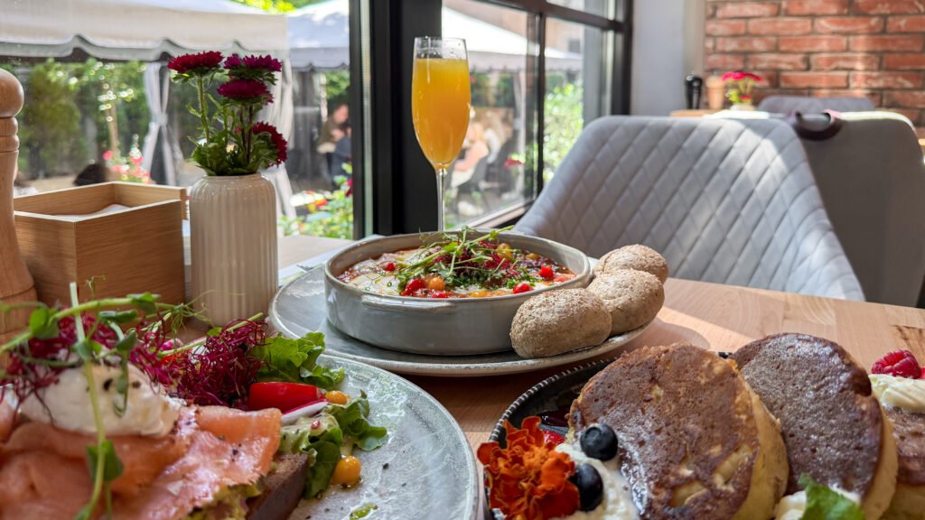 Brunch by EmberCut Krakow | Krista the Explorer Brunch on a wooden table with mimosas during a weekend in Krakow.