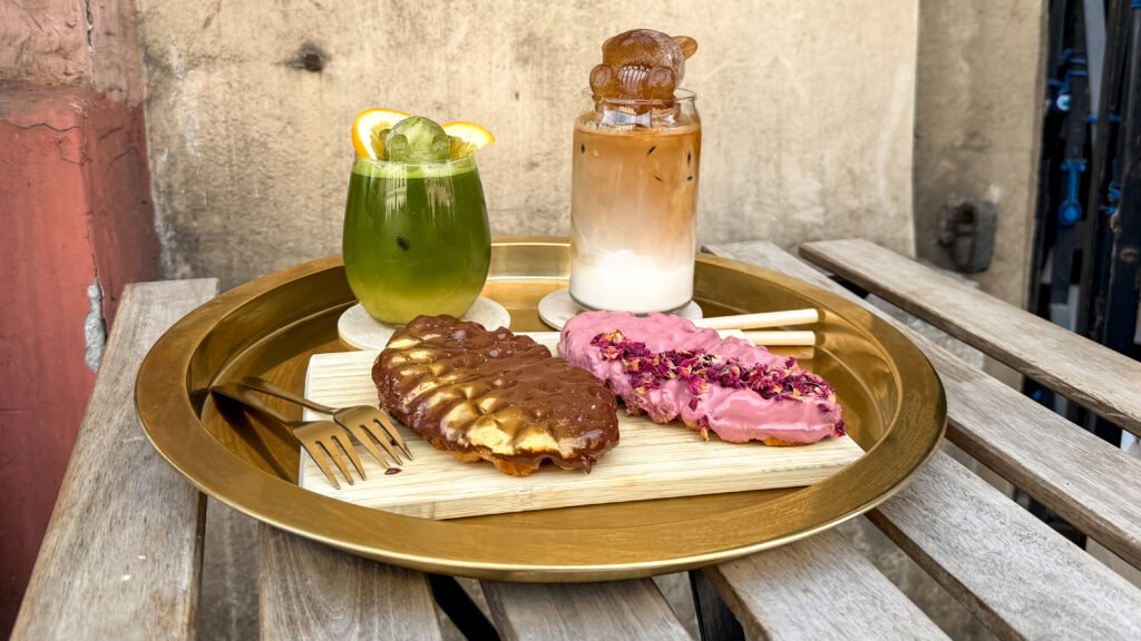 Kopi Krakow | Krista the Explorer Iced matcha and coffee with bear ice cubes and croissant-waffles topped with sauces.