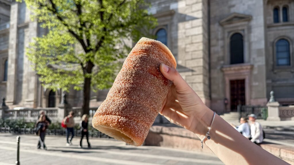 Chimney Cake coated in sugar in front of basilica in Budapest.