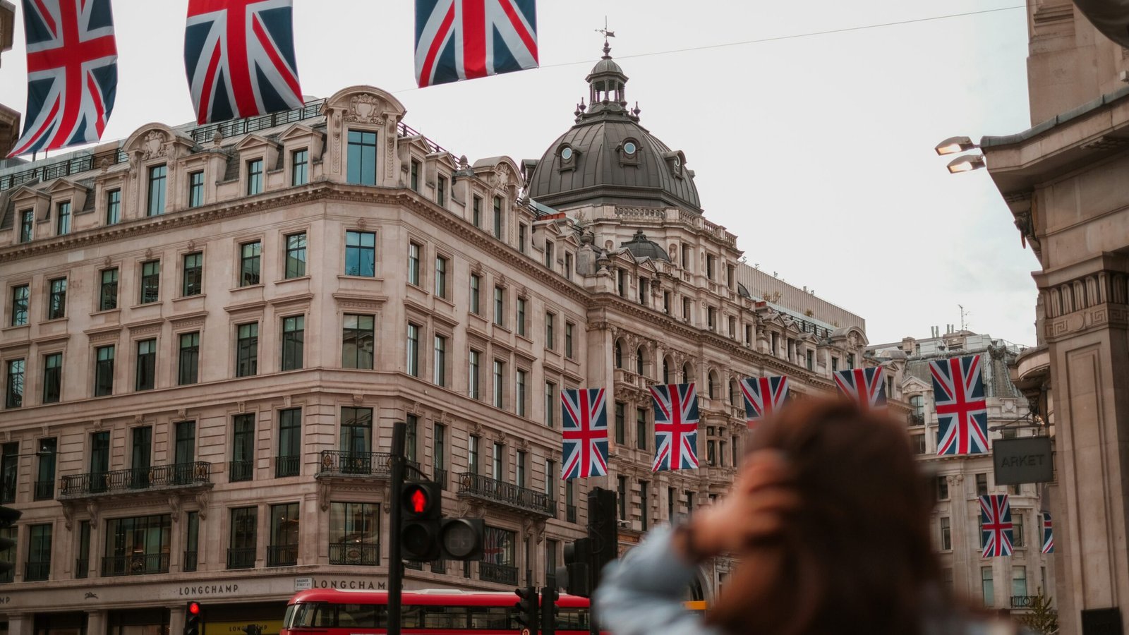 London | Krista the Explorer | Krista the Explorer Historic shopping street in London with Union Jack flags.