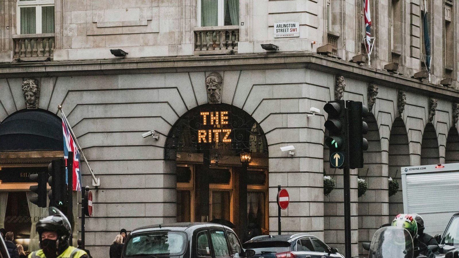 Corner of Ritz hotel in London with traffic in front.