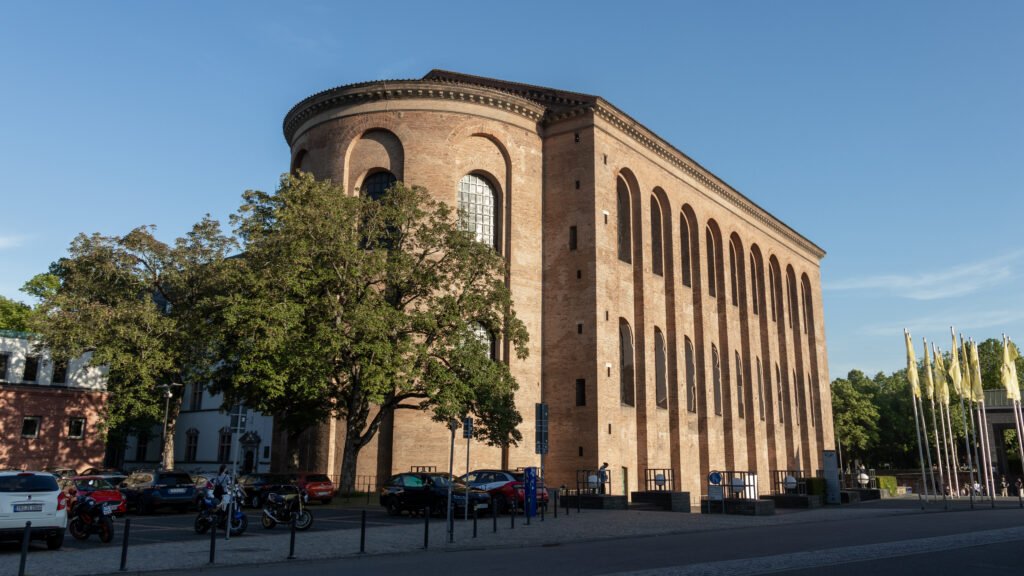 Basilica of Constantine Trier | Krista the Explorer Brick building with tall arched windows and a curved façade.