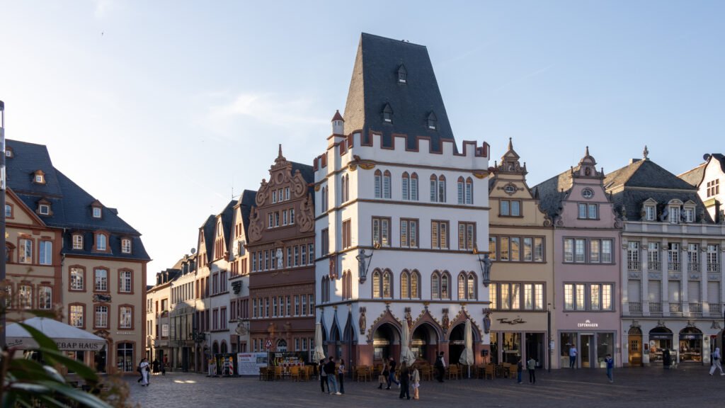 Trier Streets | Krista the Explorer Historic European square with pastel facades, ornate gables, and arched windows.