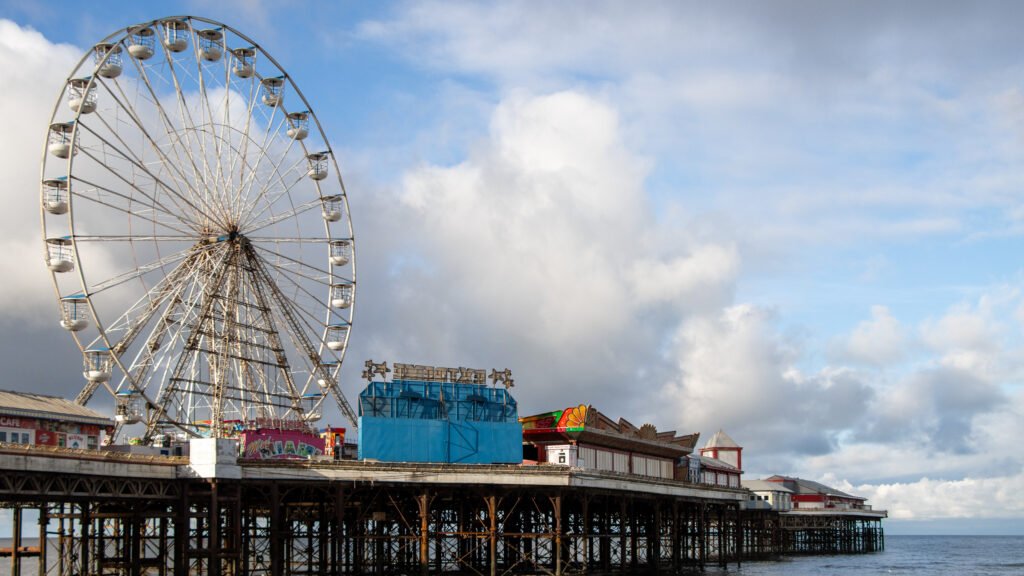 Central Pier Blackpool | Krista the Explorer Large Ferris wheel on a seaside pier with colorful buildings.