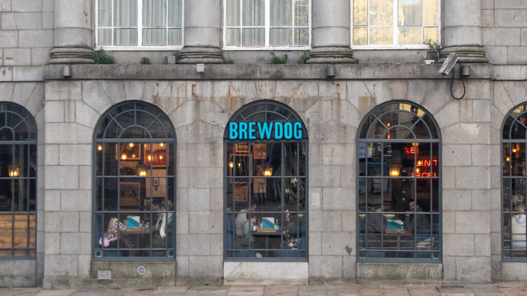 BrewDog Aberdeen | Krista the Explorer Exterior of BrewDog bar in a stone building with tall arched windows.