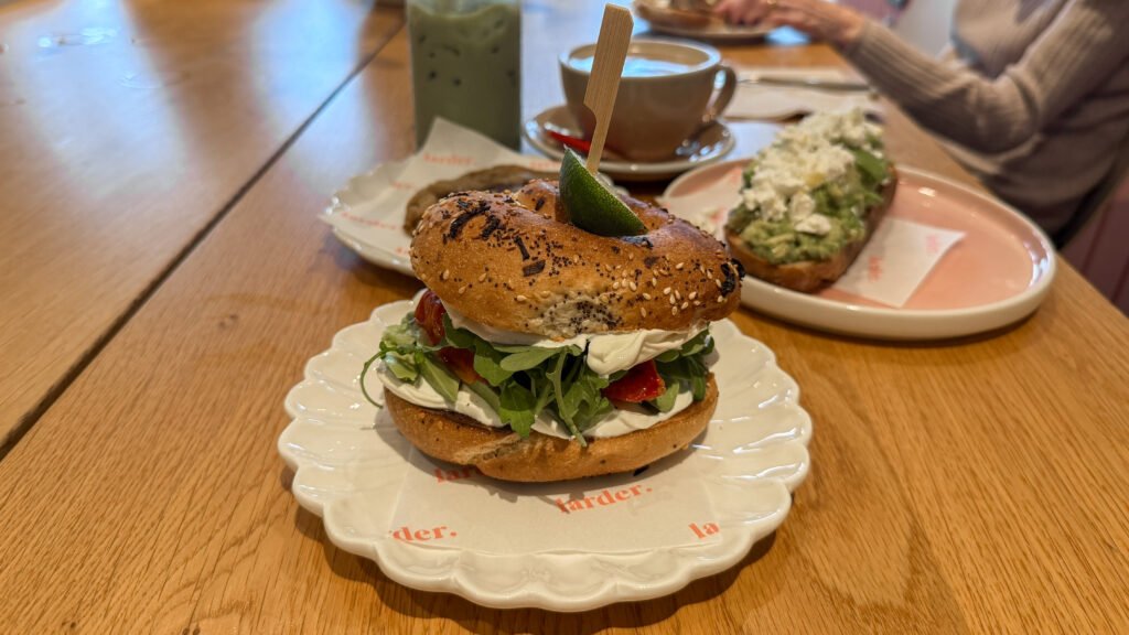 larder. Blackpool | Krista the Explorer Sesame seed bagel sandwich with cream cheese, arugula, and tomato.