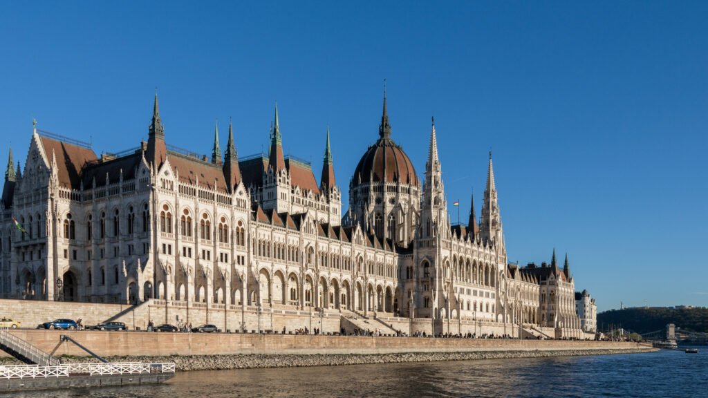 View of the Hungarian Parliament Building during river cruise at sunset.