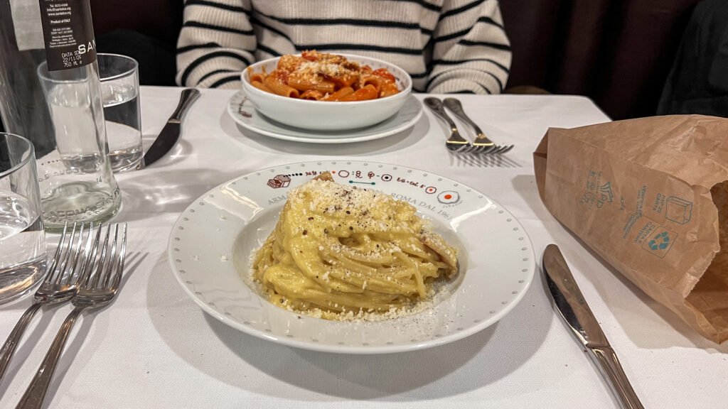 Armando al Pantheon Rome | Krista the Explorer Two pasta dishes on a white-draped table in Rome.