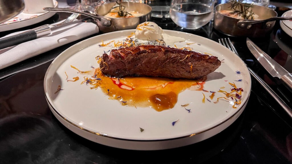 Restaurant Gabrielle Reims | Krista the Explorer Seared duck on a white plate with orange sauce.