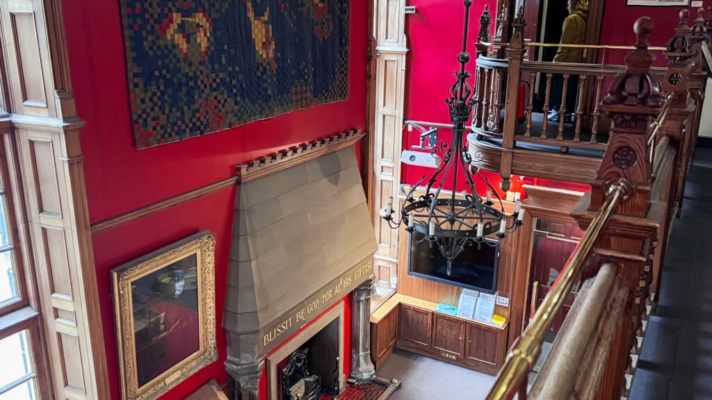 The Writers’ Museum Edinburgh | Krista the Explorer Interior of a red-walled historic room with a large stone fireplace.