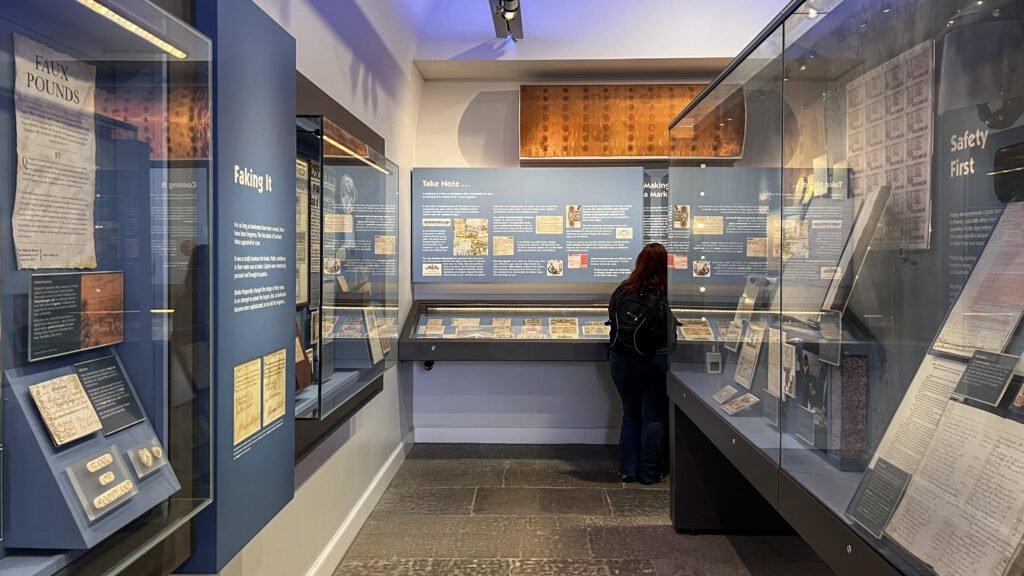 Museum on the Mound Edinburgh | Krista the Explorer Museum exhibit with glass display cases along blue walls.