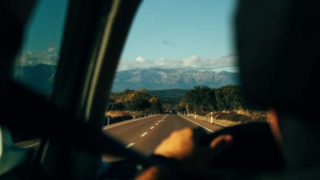 View of a straight highway disappearing into distant mountains.